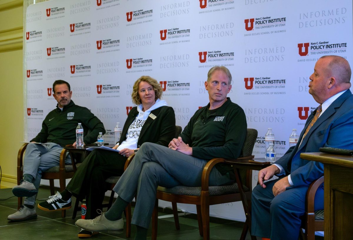 Panelists (from left to right), Brad Wilson, Jennifer Wesselhoff, Scott Doughman and Jim Harvey, discuss Milan Cortina 2026 and Utah 2034 at a meeting on March 25, 2026, at the Thomas S. Monson Center in Salt Lake City, Utah. (Photo by Leo LeBohec | The Daily Utah Chronicle)